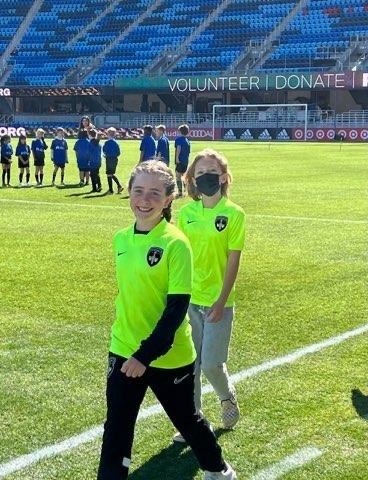 Two Sentinels players walking out onto the stadium pitch