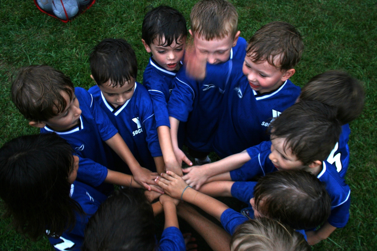 Young Sentinels players in a team huddle