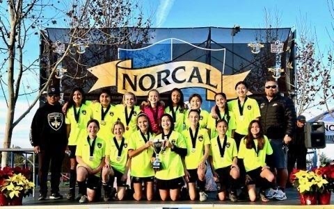 Sentinels girls team on the NorCal Premier winners podium with the championship trophy